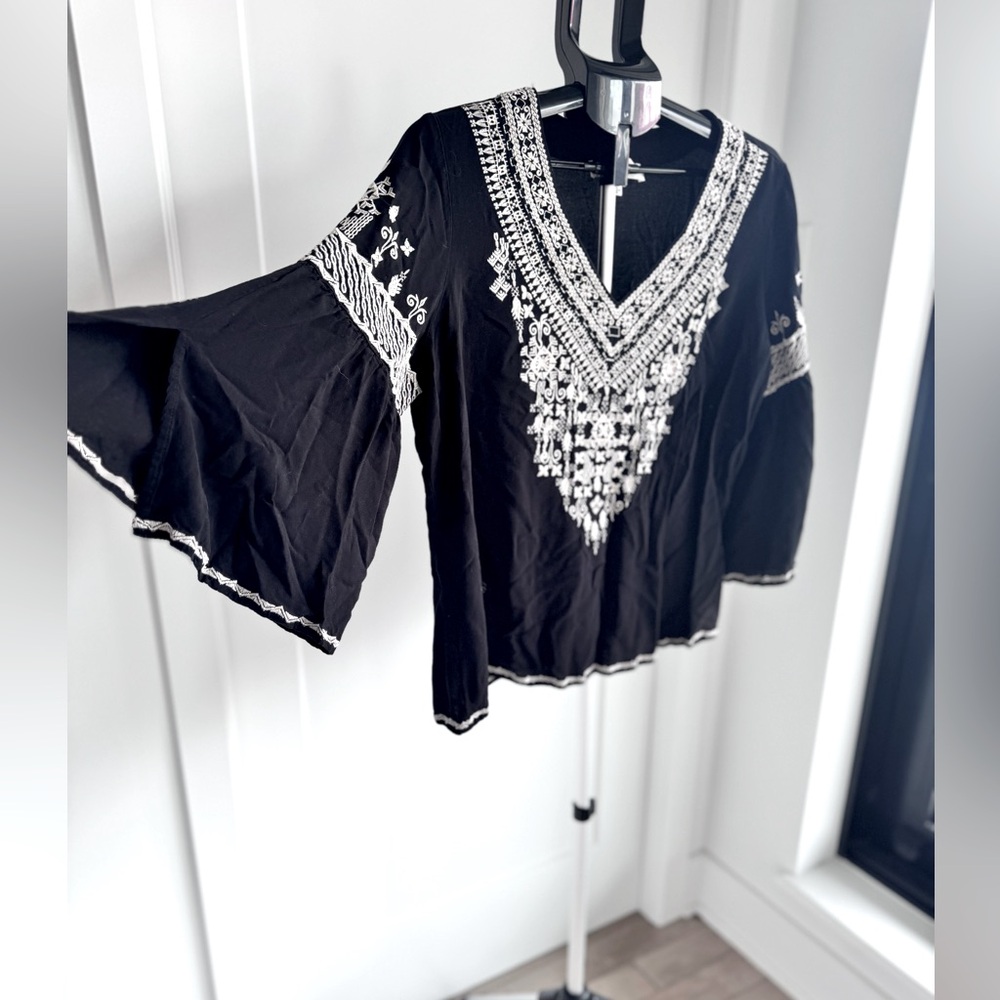 Chelsea and Theodore black bell sleeve top.
